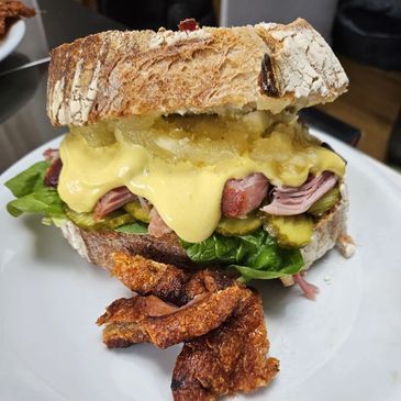 Smoked Ham Hock,sliced gherkins,apple sauce and a creamy mustard sauce, served in a bloomer