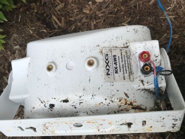 Old, rusty NXG NX-AW5 speaker with dirt marks.