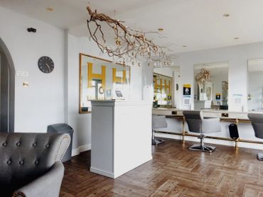 Modern, elegant hair salon interior with white decor.