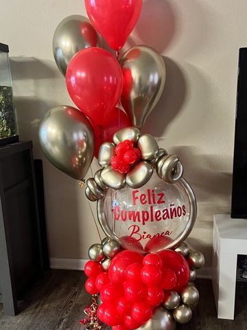 Red and gold birthday balloons arrangement.
