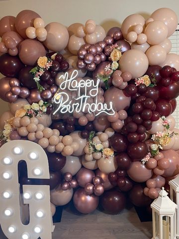 Decorative balloon arrangement with Happy Birthday sign and letter G.