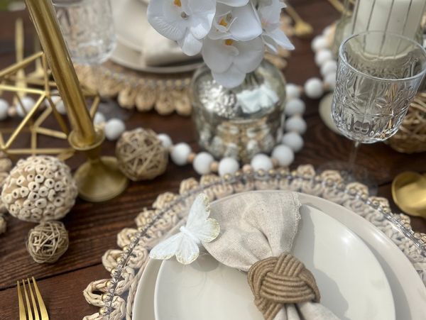 Elegant table setting with white and neutral tones.