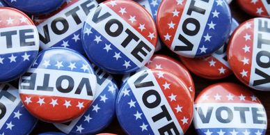 Red and blue 'VOTE' buttons with stars, symbolizing elections.