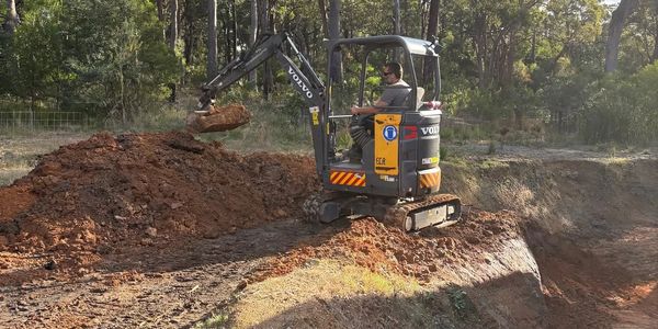 Tom Jensen operating his 1.8 tonne excavator on a bush block near Batemans Bay