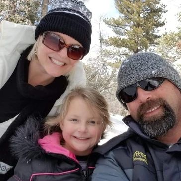 Home Inspector Justin Vander Woude, wife, and grand daughter enjoying a snow day in the mountains. 