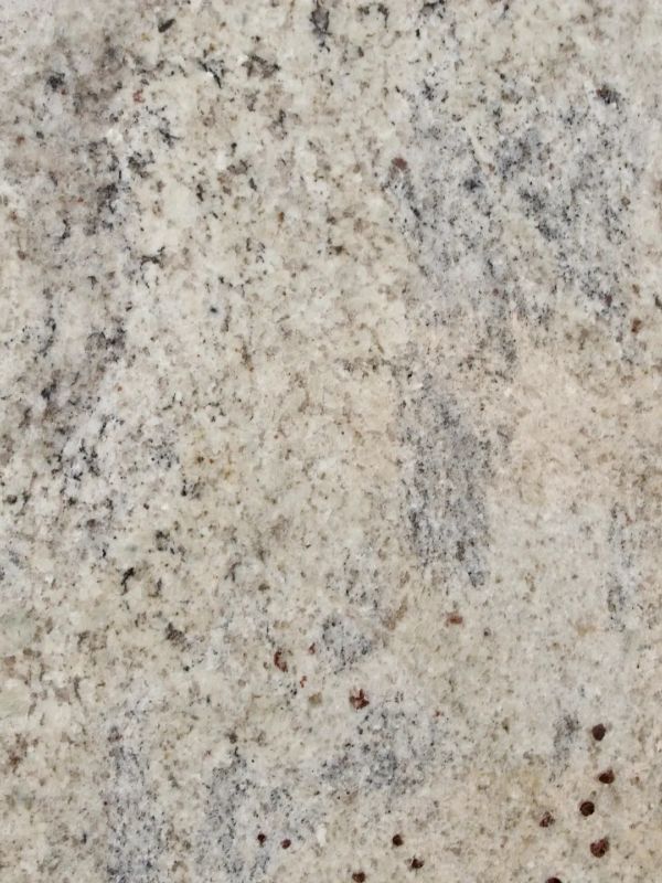 Close-up of a light granite surface with speckled patterns.