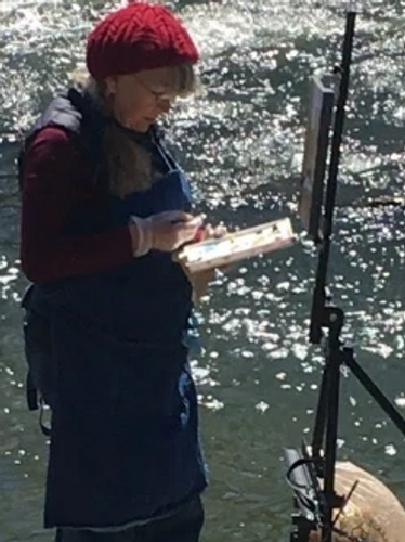 photo of Laurie De Camillis painting at the edge of the Don River