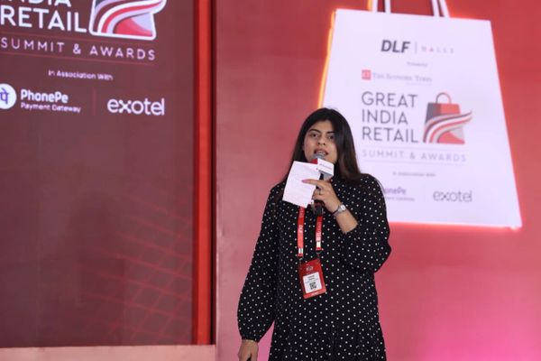 Woman speaking at the Great India Retail Summit &amp; Awards event.