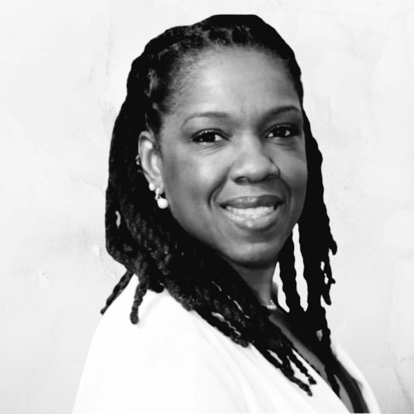 Black and white portrait of a smiling woman with braided hair.