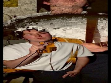 Man holding a yellow drill, distorted by digital glitches.