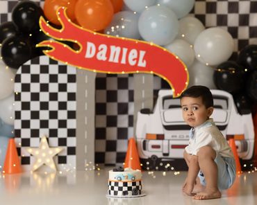 hot wheels cake smash session with little boy in blue at chino hills photography studio.