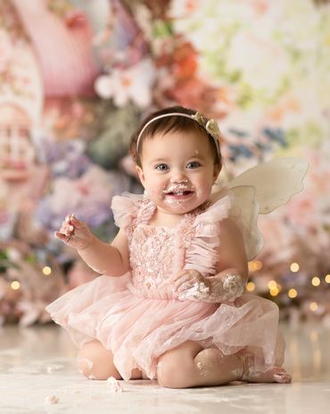 fairy first birthday cake smash  girl smiling with  cake corona photography studio inland empire.