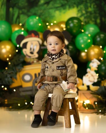 safari Mickey Mouse cake smash session of little boy in safari outfit during his custom cake smash.