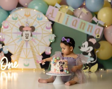 Pastel Disney cakesmash session with little girl touching cake at studio session in Chino Hills, Ca.