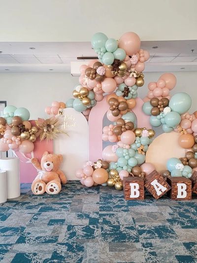 A beautiful balloon display with balloon arches and balloon columns, for a baby shower.