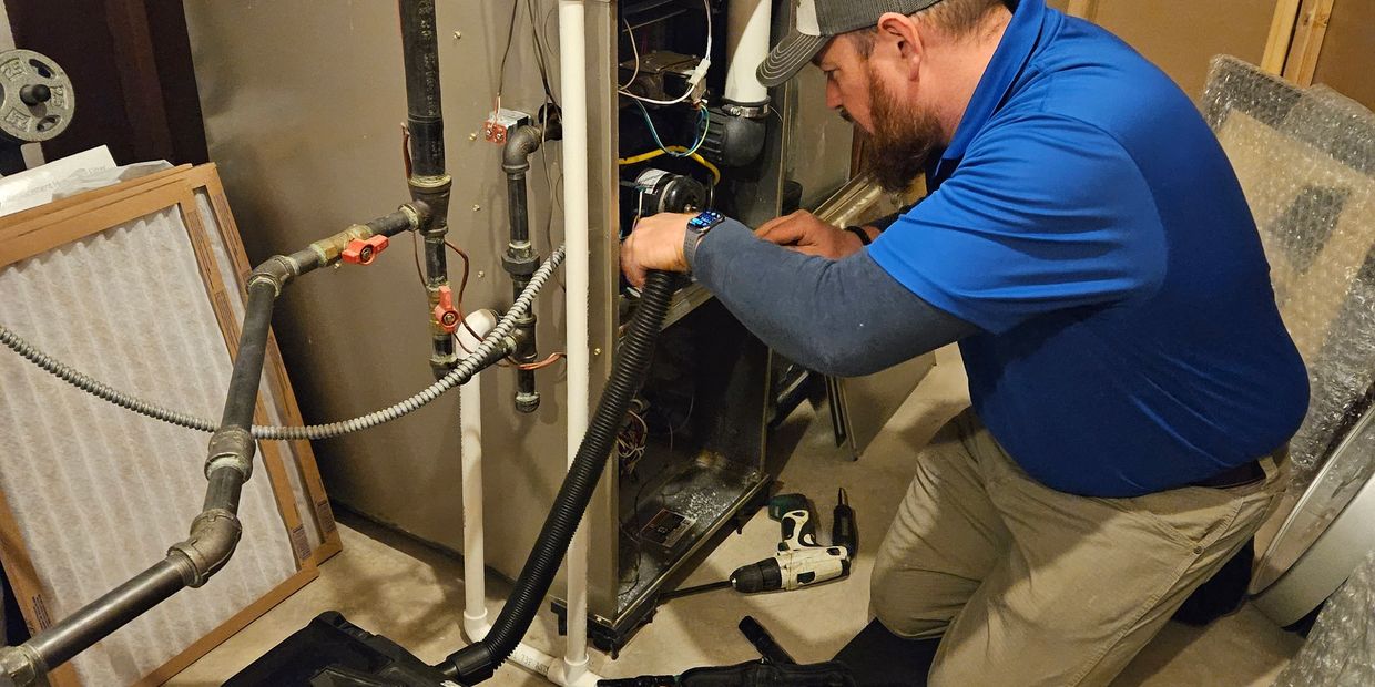 hvac technician working on furnace