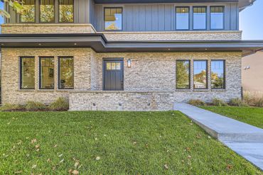 Modern house exterior with brick and stone facade.