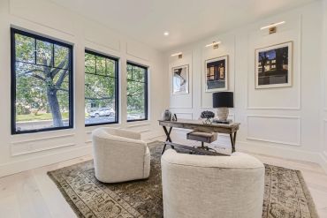 Modern home office with a desk and two chairs.