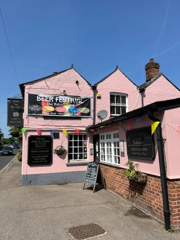Pink pub advertising a beer festival on a sunny day.