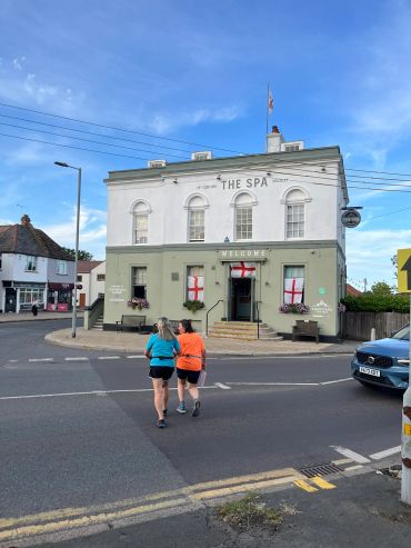 Two women walking towards a building named The Spa.
