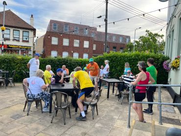 Group of people socializing outdoors on a patio.