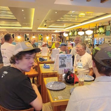A group of people dining in a cozy, well-lit restaurant.