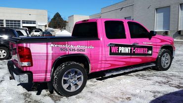Bright pink truck advertising T-shirt printing in Keswick, Ontario.