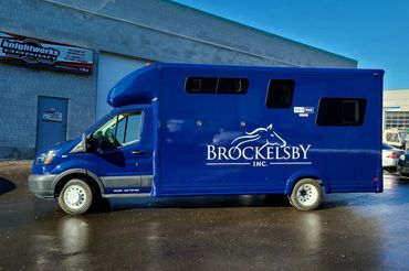 Custom Ford Transit van wrapped from silver to gloss blue.