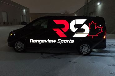 Night photo of a black van with illuminated Rangeview Sports logo and Canadian maple leaf.