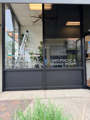 Chiropractic and massage therapy storefront windows.