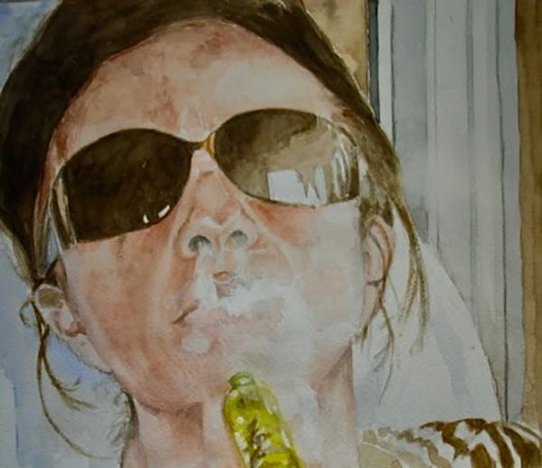 A person wearing sunglasses, exhaling smoke, holding a green vape device.