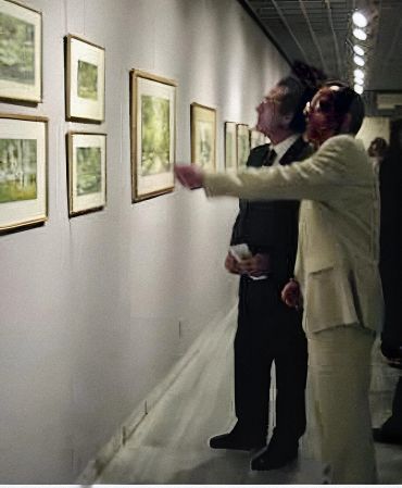Two people viewing art in a dimly lit gallery with motion blur effect.