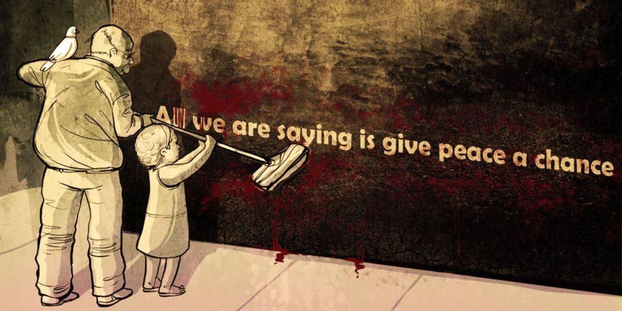 Man and child painting a peace message on the wall.