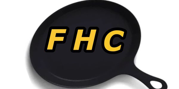 Black cast iron skillet with bold yellow letters FHC.