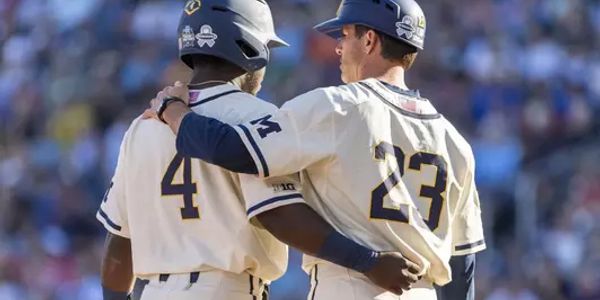 Two baseball players embracing during a game.