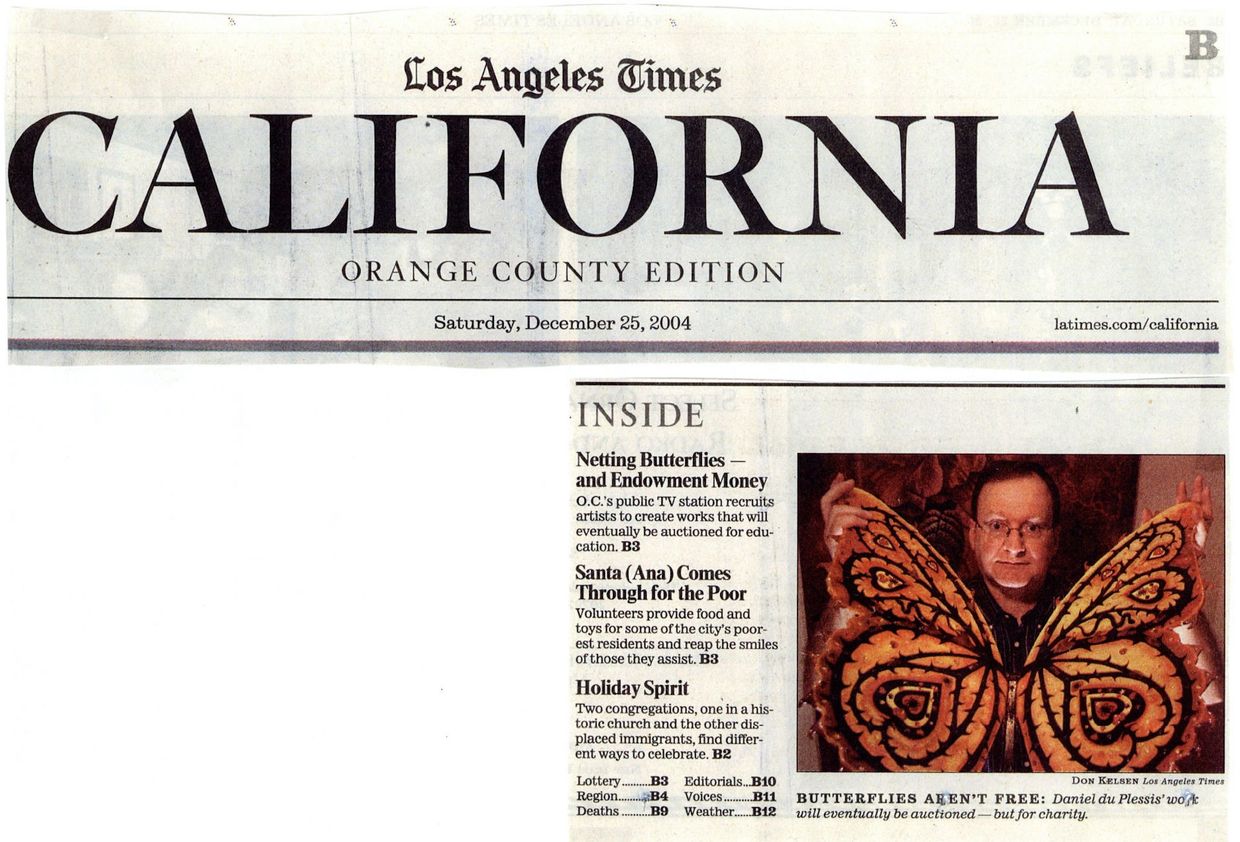 Man holding sculpture of butterfly.