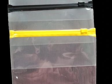 Two transparent plastic zipper bags, one with a black zipper and one with a yellow zipper.