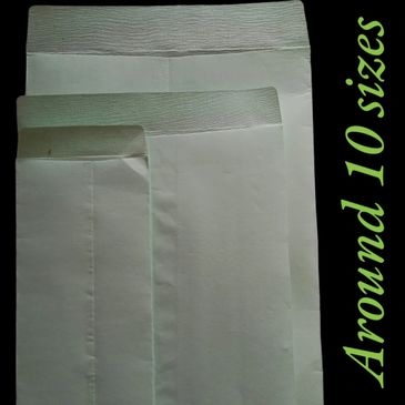 Three white cloth covers of different sizes displayed on a black background.