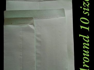 Three white cloth covers of different sizes displayed on a black background.