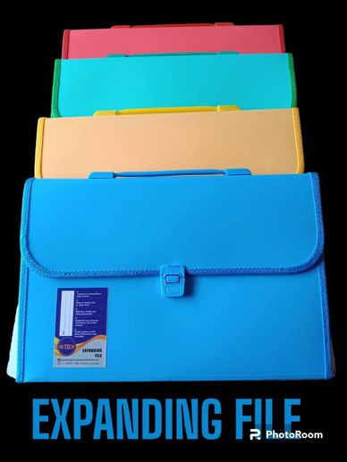 Colorful expanding file folders neatly stacked on black background.