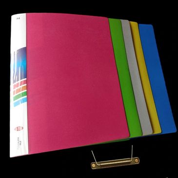 Colorful binders arranged in a row with a black background.