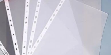 A set of clear plastic sheet protectors with punched holes.