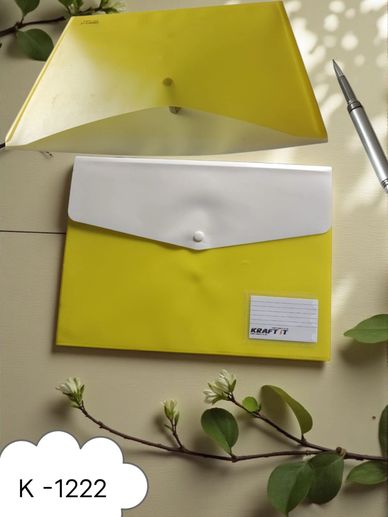 Yellow and white plastic folders on a table with a pen and plant branch.