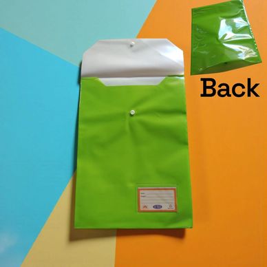 Open green document pouch with a snap button on colorful background.