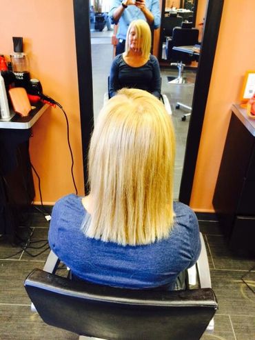 a woman sitting in chiar at a salon 