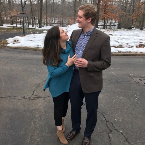 Couple smiling and looking at each other outdoors in winter.