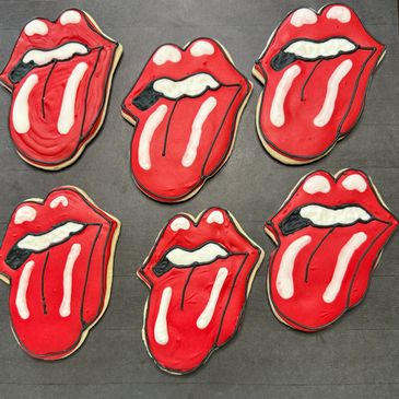 Cookies shaped like red lips with tongues sticking out.