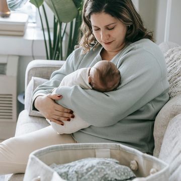 mother holding her new baby in-home 