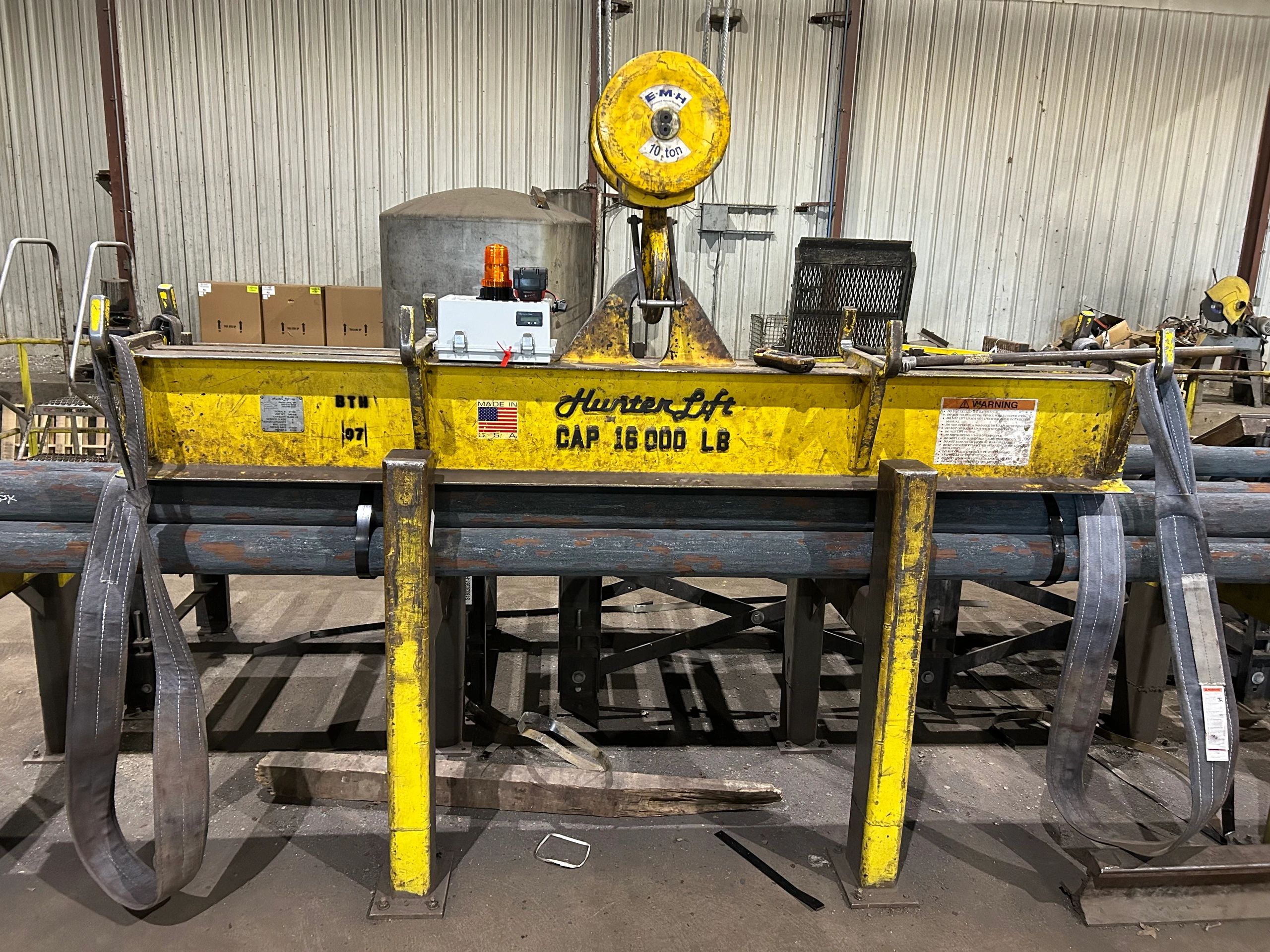 A yellow industrial Hunter Lift with 16,000 lb capacity in a warehouse.