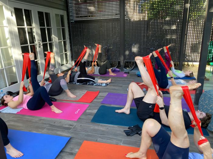 A small group exercise class stretching with bands